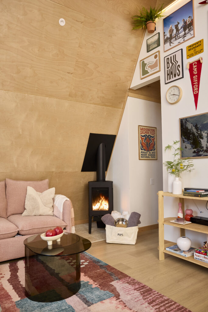 Living room with a gas fireplace, sofa, and curated gallery wall
